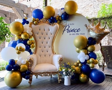 Prince-themed balloon arrangement featuring a throne and crown decor