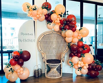 Elegant wedding balloon decor with throne seating